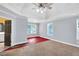 Primary bedroom with ceiling fan, and connecting bathroom and closet space at 5735 Lake Windsor Pkwy, Buford, GA 30518