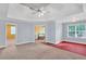 Large primary bedroom with tray ceilings, ceiling fan and ensuite bathroom at 5735 Lake Windsor Pkwy, Buford, GA 30518