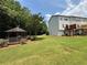 A tranquil gazebo sits in the backyard, surrounded by lush greenery and a well-manicured lawn at 6798 Blackstone Pl # 12, Mableton, GA 30126