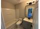 Well-lit bathroom with a tub-shower combo, gray vanity, and modern fixtures at 6798 Blackstone Pl # 12, Mableton, GA 30126