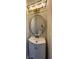 Bathroom featuring a circular mirror, updated vanity, and modern lighting fixtures at 6798 Blackstone Pl # 12, Mableton, GA 30126