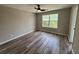 Bedroom featuring wood-look flooring, ceiling fan, and large window at 6798 Blackstone Pl # 12, Mableton, GA 30126