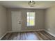 Bright, spacious bedroom featuring modern wood-look flooring and a rear access door at 6798 Blackstone Pl # 12, Mableton, GA 30126