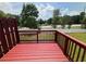 Exterior view of deck overlooking yard, with a glimpse of surrounding greenery and neighborhood at 6798 Blackstone Pl # 12, Mableton, GA 30126