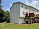 Back of home with green lawn, deck, and tidy landscaping at 6798 Blackstone Pl # 12, Mableton, GA 30126
