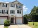 Charming townhome with a two-car garage, brick accents, and lush landscaping at 6798 Blackstone Pl # 12, Mableton, GA 30126