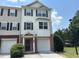Charming townhome with a two-car garage, brick accents, and lush landscaping at 6798 Blackstone Pl # 12, Mableton, GA 30126