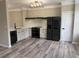 A modern kitchen boasts stainless steel appliances, quartz countertops, and hardwood flooring at 6798 Blackstone Pl # 12, Mableton, GA 30126