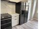 Kitchen view features a large stainless steel refrigerator, quartz countertops, and an electric stove at 6798 Blackstone Pl # 12, Mableton, GA 30126