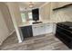 Modern kitchen featuring white cabinets, quartz countertops, stainless steel appliances, and hardwood floors at 6798 Blackstone Pl # 12, Mableton, GA 30126
