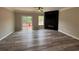 Open living room featuring wood-look flooring, sliding door, and a sleek fireplace at 6798 Blackstone Pl # 12, Mableton, GA 30126