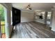 Open living room featuring wood-look flooring, sliding door, and a sleek fireplace at 6798 Blackstone Pl # 12, Mableton, GA 30126