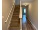 Inviting staircase with plush carpeting and a modern wood accent wall at 6798 Blackstone Pl # 12, Mableton, GA 30126