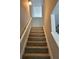 Well-lit staircase featuring neutral walls and carpet steps at 6798 Blackstone Pl # 12, Mableton, GA 30126