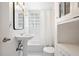 Bathroom featuring a pedestal sink, black-framed mirror and tiled shower/tub combo at 830 Barnett Ne St # 2, Atlanta, GA 30306