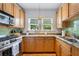 Bright kitchen showcasing stainless steel appliances, wood cabinets, and granite countertops at 830 Barnett Ne St # 2, Atlanta, GA 30306