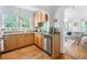 Cozy kitchen featuring light wood cabinets, granite countertops, and a stainless steel dishwasher at 830 Barnett Ne St # 2, Atlanta, GA 30306