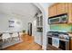 Modern kitchen with stainless steel appliances, light wood cabinets, and eat-in dining area at 830 Barnett Ne St # 2, Atlanta, GA 30306