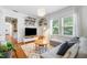 Bright living room with a modern design, floating bookshelves, and a comfortable gray sectional at 830 Barnett Ne St # 2, Atlanta, GA 30306