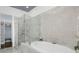 A stylish bathroom featuring a modern glass-enclosed shower and a freestanding soaking tub at 328 Brownstones Cir, Atlanta, GA 30312