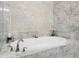 Soaking tub with marble surround and elegant fixtures, creating a relaxing and luxurious bathing experience at 328 Brownstones Cir, Atlanta, GA 30312