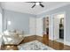 Bright bedroom with a ceiling fan, beautiful floors, a comfortable sitting area, and neutral paint at 328 Brownstones Cir, Atlanta, GA 30312