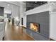 Modern fireplace with a sleek tile surround, built-in cabinets, and hardwood floors at 328 Brownstones Cir, Atlanta, GA 30312