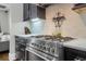 Gourmet kitchen featuring stainless steel gas range, marble counters, and modern backsplash at 328 Brownstones Cir, Atlanta, GA 30312