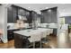 Stylish kitchen with dark cabinetry, marble countertops, and seating at the island at 328 Brownstones Cir, Atlanta, GA 30312