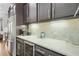Kitchen counter with wine refrigerator, coffee maker, and open shelving at 328 Brownstones Cir, Atlanta, GA 30312