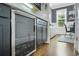Kitchen wine cooler with wine bottles, next to dining area with black chairs at 328 Brownstones Cir, Atlanta, GA 30312