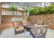 This covered patio provides a comfortable seating area with outdoor furniture and brick surround at 328 Brownstones Cir, Atlanta, GA 30312