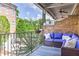 Relax on the patio with a lovely wrought iron fence, a plush outdoor sofa, and scenic views at 328 Brownstones Cir, Atlanta, GA 30312