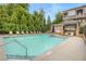 This community pool offers ample seating, umbrellas for shade, and a nearby brick structure at 328 Brownstones Cir, Atlanta, GA 30312