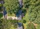 An aerial view of a home in a lush neighborhood, with mature trees surrounding a landscaped yard at 4105 Vicksburg Dr, Lawrenceville, GA 30044