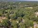 An elevated view shows a green residential neighborhood featuring tree canopies, and manicured lawns at 4105 Vicksburg Dr, Lawrenceville, GA 30044