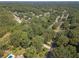 The overhead view highlights a verdant neighborhood with tree-covered streets, and manicured lawns at 4105 Vicksburg Dr, Lawrenceville, GA 30044