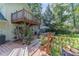 Expansive multi-tiered deck with lush plants, perfect for outdoor dining and relaxation, adds charm to the backyard at 4105 Vicksburg Dr, Lawrenceville, GA 30044