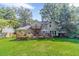 Expansive backyard featuring a wooden deck, ideal for outdoor dining and relaxation with picturesque views of the home at 4105 Vicksburg Dr, Lawrenceville, GA 30044