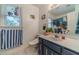 Bright bathroom featuring blue vanity with white marble countertop and a decorative shower curtain at 4105 Vicksburg Dr, Lawrenceville, GA 30044