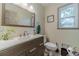 Bathroom featuring a wood vanity with modern faucet, framed mirror, and updated toilet at 4105 Vicksburg Dr, Lawrenceville, GA 30044
