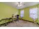 Bright bedroom featuring a desk, chair, and windows with decorative curtains at 4105 Vicksburg Dr, Lawrenceville, GA 30044