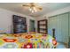 Bedroom featuring a bed with a colorful quilt, ceiling fan, tv, and a closet at 4105 Vicksburg Dr, Lawrenceville, GA 30044