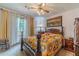 Cozy bedroom featuring a bed with a colorful quilt, wooden furniture, and natural light at 4105 Vicksburg Dr, Lawrenceville, GA 30044