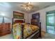 Comfortable bedroom featuring a bed with colorful quilt, wooden furniture and natural light at 4105 Vicksburg Dr, Lawrenceville, GA 30044