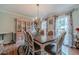 Traditional dining room with hardwood floors, floral curtains, and a classic chandelier at 4105 Vicksburg Dr, Lawrenceville, GA 30044