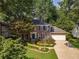 Traditional two-story home with a well-manicured front yard, featuring a brick facade and attached two-car garage at 4105 Vicksburg Dr, Lawrenceville, GA 30044