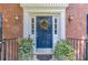 Close up of a beautiful front door with a decorative wreath and potted plants at 4105 Vicksburg Dr, Lawrenceville, GA 30044
