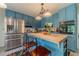 A blue kitchen features stainless steel appliances and butcher block island with seating at 4105 Vicksburg Dr, Lawrenceville, GA 30044