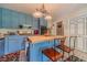 Bright kitchen with an island with a wood top, blue cabinets, and stainless appliances at 4105 Vicksburg Dr, Lawrenceville, GA 30044